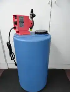 Blue water treatment tank with red control unit in a laboratory setting.