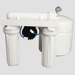 Water filtration system with white housing and blue tubing, installed on a water treatment site.