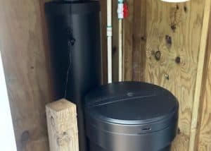 Water softener system installed in a wooden enclosure at Aqua Systems.