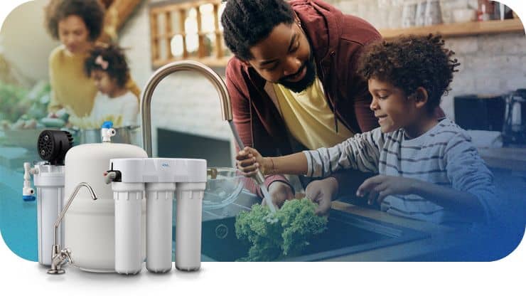 Family testing water at kitchen sink with Aqua Systems water filter system.