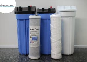 Water filtration system components including filters and tanks for water treatment.