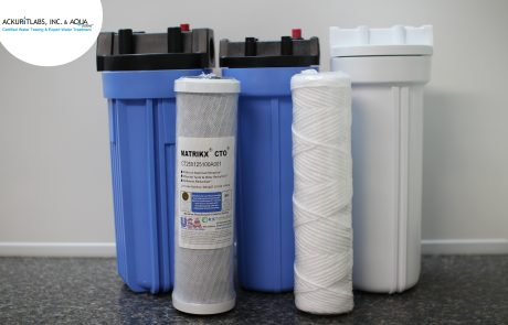 Water filtration system components including filters and tanks for water treatment.