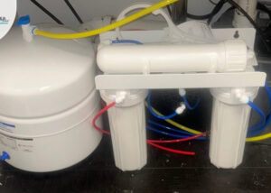 Reverse osmosis water filtration system installed in a residential setting.
