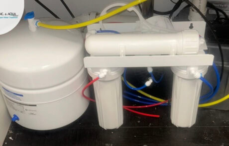 Reverse osmosis water filtration system installed in a residential setting.